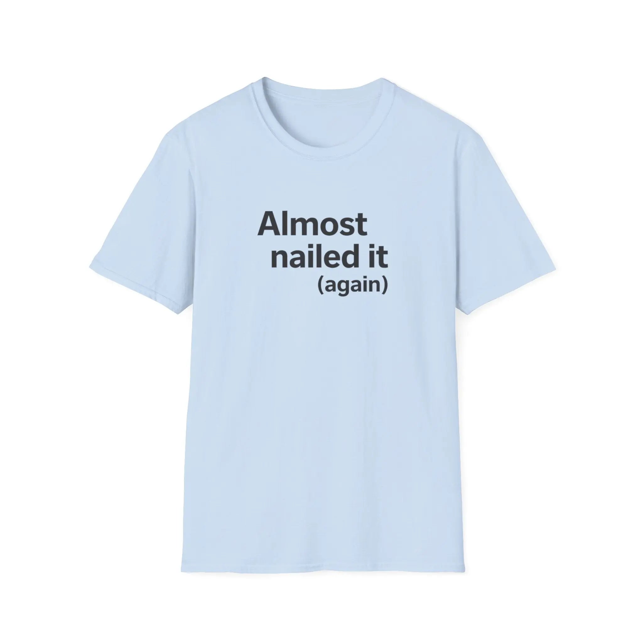 Light blue t-shirt with text 'Almost nailed it (again)' on a white background